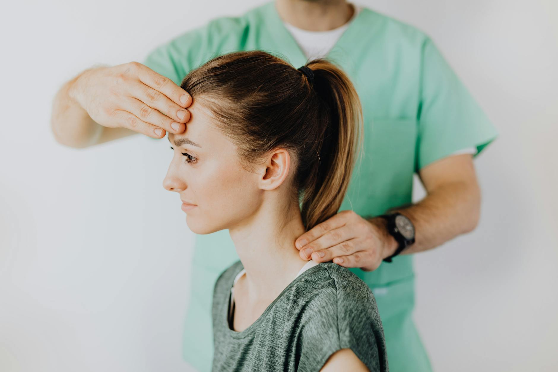 Chiropractor performing gentle spinal adjustment on patient lying on treatment table, professional medical office setting, warm clinical lighting, doctor in white coat, calm and reassuring body language, photorealistic medical photography